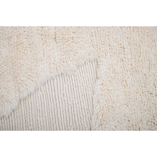 Subtle texture, quiet luxury. This hand-knotted Moroccan wool rug embraces understated elegance with a soft buttercream...
