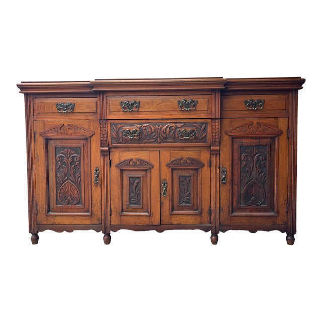 Antique Victorian Walnut Sideboard Featuring Intricate Hand Carvings and Original Ornate Brass Hardware For Sale