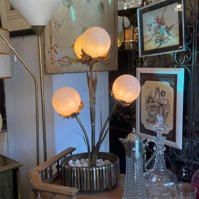 Gold floral lamp in the Maison Jansen style. Its structure is metal and features an oval base, resembling a planter, with...
