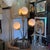 Gold floral lamp in the Maison Jansen style. Its structure is metal and features an oval base, resembling a planter, with...