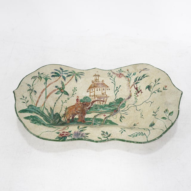 This charming vintage scalloped decorative tray features a whimsical, hand-painted exotic jungle scene set against a...