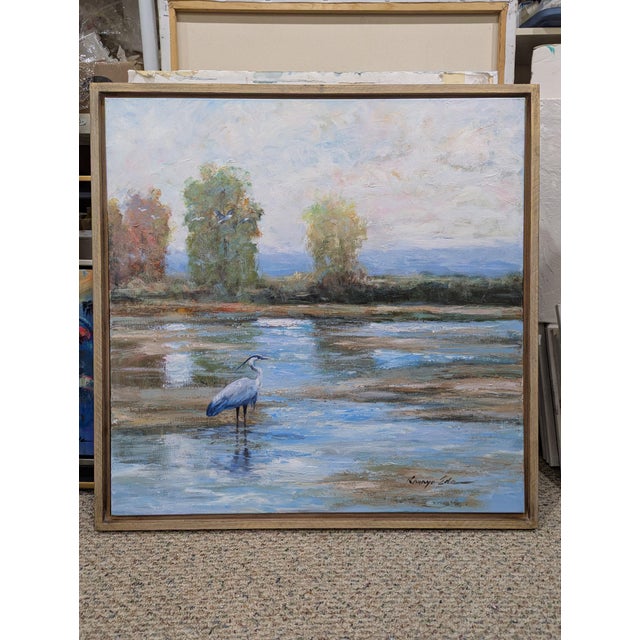 Swamp Scenery. Big Landscape Art With a Great Blue Heron Framed with a tan wood floater frame.