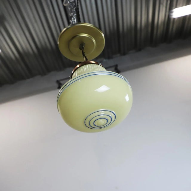 Circa 1930. We offer this Art Deco, pendant light features a ridged milk glass. Excellent vintage conditions.