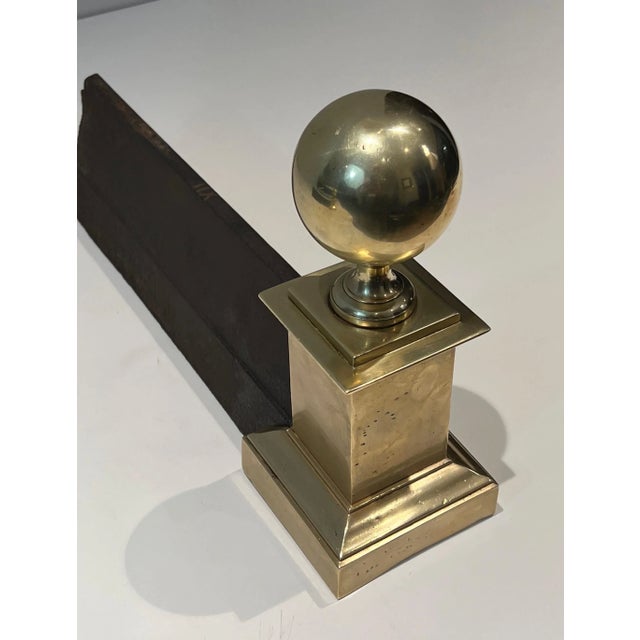 This large neoclassical style andirons are made of brass. This is a French work. Circa 1970.