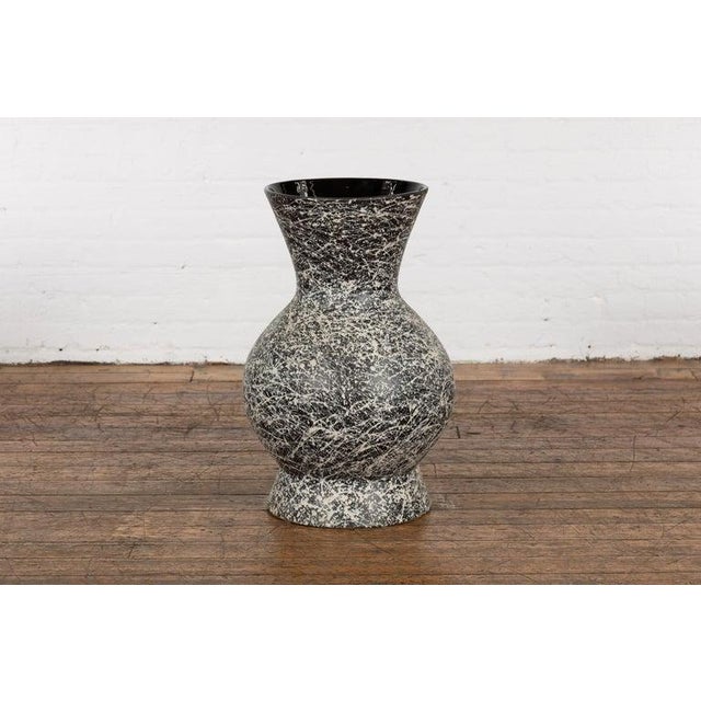 An artisan Prem Collection ceramic vase with nice rounded shape, black ground, white dripping décor and black glazed...