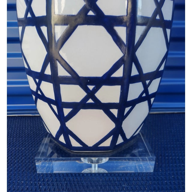 A gorgeous navy blue and white ceramic table lamp in a fabulous crosshatch basket weave design. The lamp comes with the...