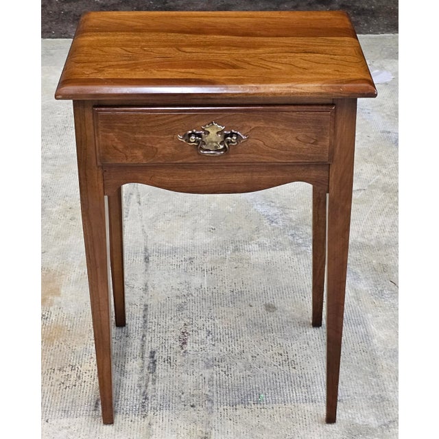 A Mid Century Cherry House Single Drawer Side Table. Measures 19" in width, 14.5" in depth, 26" in height.