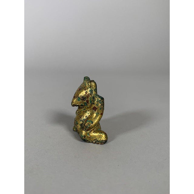 An exceptional ornamental bronze sculpture from the Han Dynasty (206 BC-220 AD). It depicts a gilded bronze bear . A...