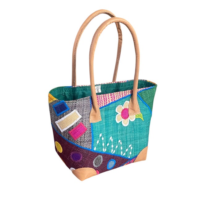 This colorful hand made Sewn and Embroidered Raffia /leather Tote Bag from Madagascar showcases traditional raffia weaving...
