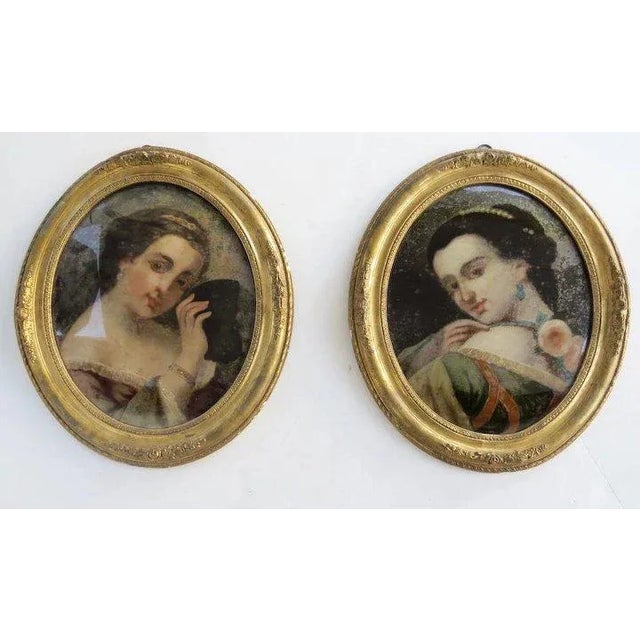 Pair of reverse painted portraits in original frames. c 1860 Measures 20" by 23 1/2" Some losses.