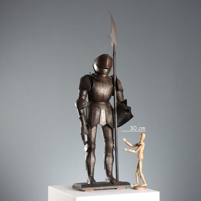 Model of a soldier's armor with a lance, finely engraved with a leafy scroll decoration. The breastplate and shield...