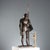 Model of a soldier's armor with a lance, finely engraved with a leafy scroll decoration. The breastplate and shield...