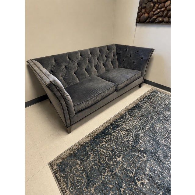 This Ethan Allen "Shelton" style tuxedo sofa is upholstered in a blue/gray velvet. It beautifully blends the Chesterfield...