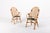 1970’s rattan and bamboo frame chairs with leather straps bindings. Seats upholstered in green patterned fabric. It could...