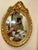 Rococo Oval Wall Mirror With Floral Center Detail & Gold Leaf Frame For Sale - Image 3 of 4