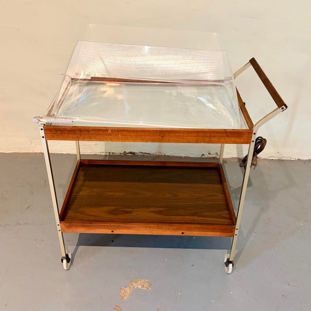 A fabulous vintage Salton Hotray rolling serving/bar cart featuring warm wood shelving, a slender metal frame, wood-...