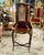 An exquisite French Louis XV style display cabinet featuring a beautifully crafted vitrine elevated on an elegant console...