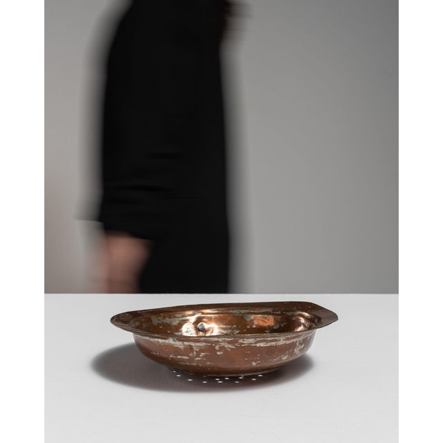 This early 19th century serving piece from Belgium is finished in terra cotta, worked in copper. Its form follows honest,...