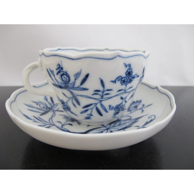 Meissen porcelain coffee cup and saucer set in classic Blue Onion (Zweibelmuster) pattern. Scalloped rim on cup and...