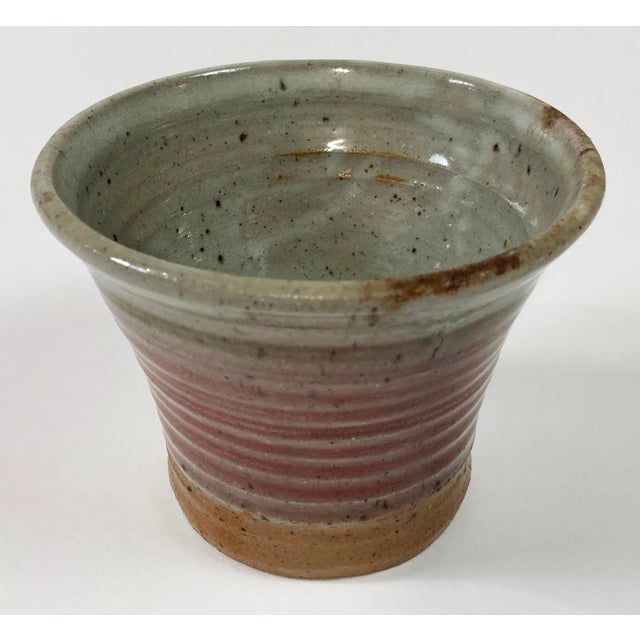 Vintage studio pottery vessel with swirls of blush and gray through body with rich rust tones towards base. Signed by...