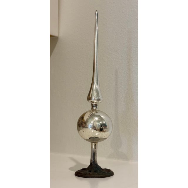 This lovely antique mercury glass Christmas tree topper is displayed atop this antique metal ticket/receipt holder. The...