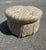 Sherrill Ottoman in a Beautiful Paisley Pattern of earth tone colors in a round design and comes complete on rollers.