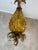 An elegant Italian pendant light from the 1960s, crafted from amber Murano glass and gilt brass, in the refined shape of a...