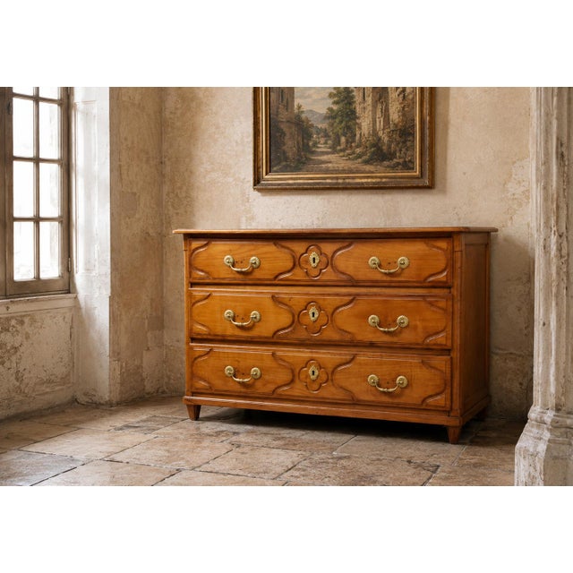 Louis XV Cherrywood Commode – 18th Century An elegant solid cherrywood commode with three large drawers in the front. This...
