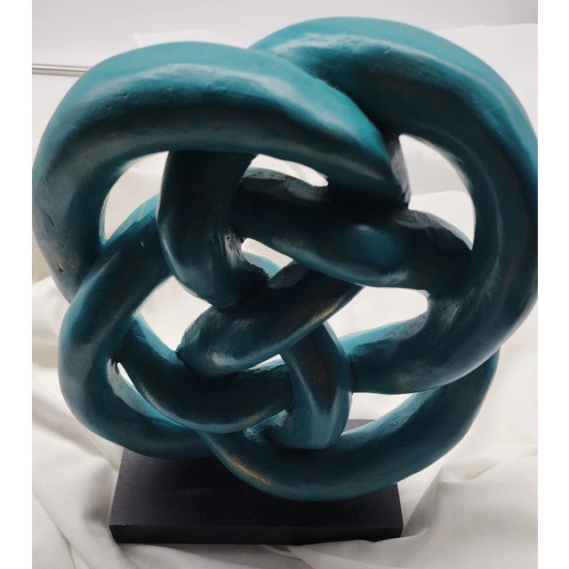 A truly talented artisan hand carved this complex piece from wood. The infinity design reflects that the knot has no...