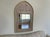 Large 1990s Bombay Company Neoclassical Urn Trumeau Mirror Hand Painted Gold Leaf This grand arched wall mirror is a...