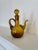 This vintage amber glass blown pitcher is crafted beautifully with a removable stopper. Its amber color varies from light...