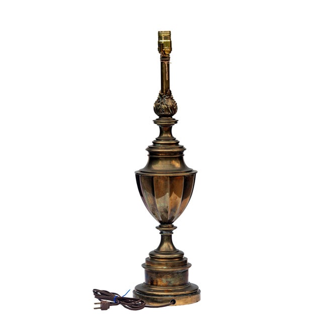 Regency style American Stiffel table lamp with 12 sided solid brass earned trophy body topped with an ornate a campus....