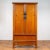 A Chinese Ming dynasty style elmwood wardrobe from the early 20th century, with two doors, hidden drawers and carved...