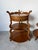 A beautiful pair of vintage Grosfeld House three-tier side tables crafted in a warm walnut finish. Each table features a...