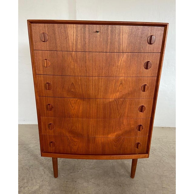 Made in denmark circa 1960 and designed by henning kjærnulf this elegant and rare teak chest of drawers is a beautiful...