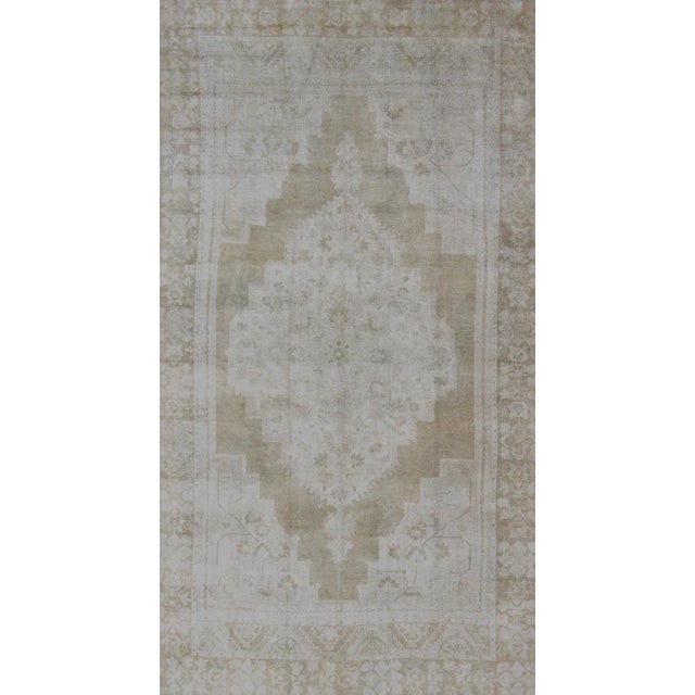 Medallion Design Vintage Oushak Rug in Muted Tones of Faded Yellow and Neutrals. Turkish Medallion Rug in Mid-Tones,...