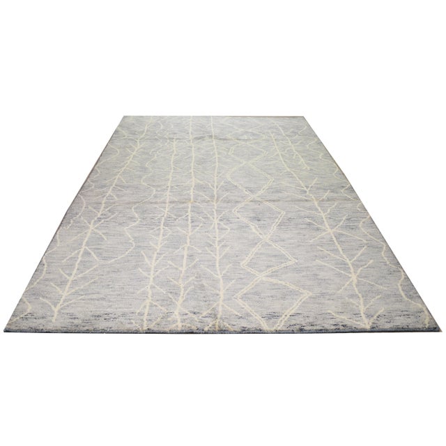 Hand-knotted with care using traditional rug-making techniques, this wool rug blends timeless craftsmanship with a modern...