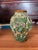 This vase is a vintage Italian majolica pottery vase featuring a highly textured, three-dimensional grape vine, leaf, and...