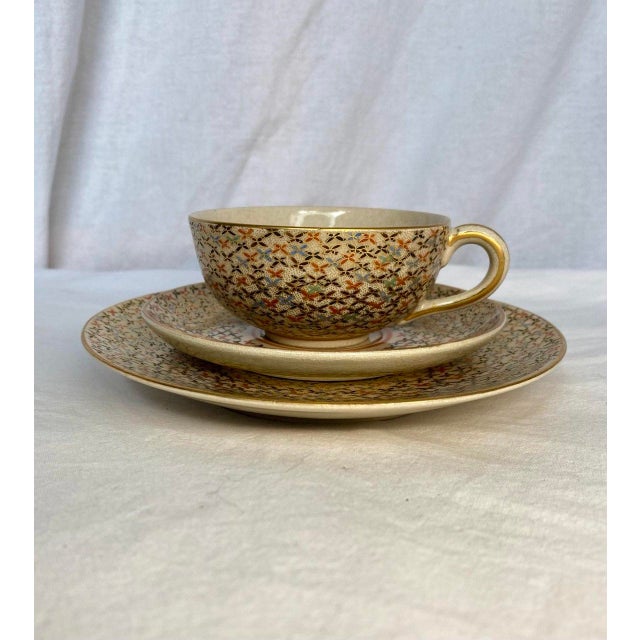 An elegant and finely detailed Japanese Satsuma tea set comprising a teacup, matching saucer, and dessert plate, all...