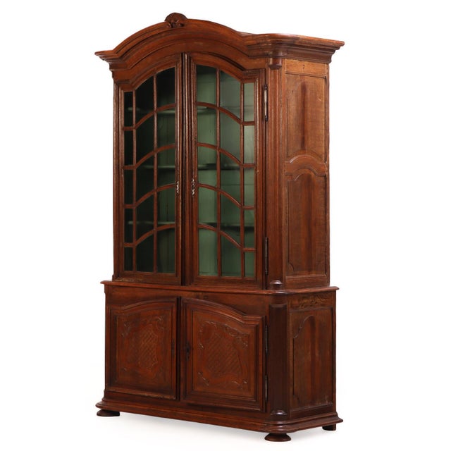 Composed of solid oak, this 19th-century French cabinet features two prominent mullioned glass doors with a very appealing...