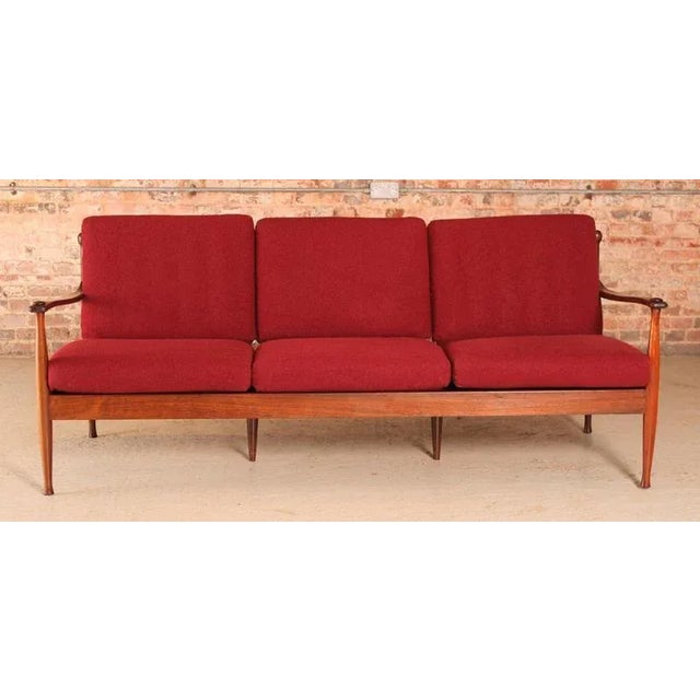 This 3-seater Danish Mid Century sofa, crafted from rosewood and upholstered in red wool, dates from the 1960s. The frame...