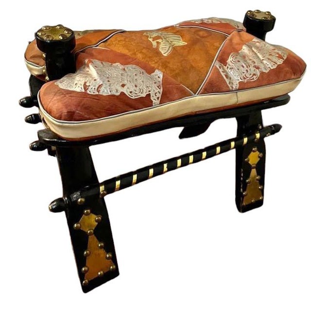A Pair of Vintage Egyptian camel embossed leather cushions saddle stools with embossed Egyptian motifs & decorative brass...