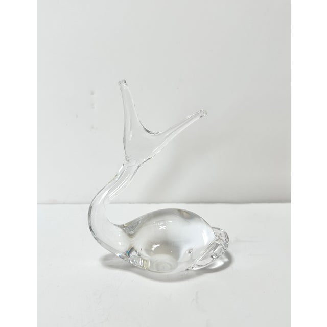 A charming vintage clear art glass snail figurine featuring a gracefully curved body and delicate pulled antennae. The...