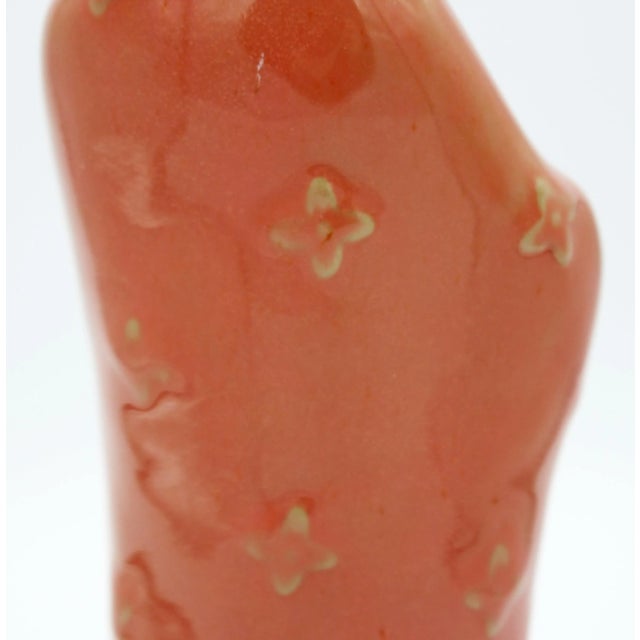 Chinese, circa 1970s, mud figure from Wanjiang, Guangong province. A lovely woman in a winter fur trimmed coat holding a...