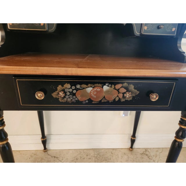 The Vintage 1980's Ethan Allen small writing desk is a beautiful and functional piece. It is made of Maple and black wood...