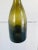 A hand crafted blown glass wine bottle. Deep green tones. French 19th century.