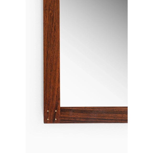 Rare mirror designed by Uno & Östen Kristiansson. Produced by Luxus in Vittsjö, Sweden. This piece is attributed to the...