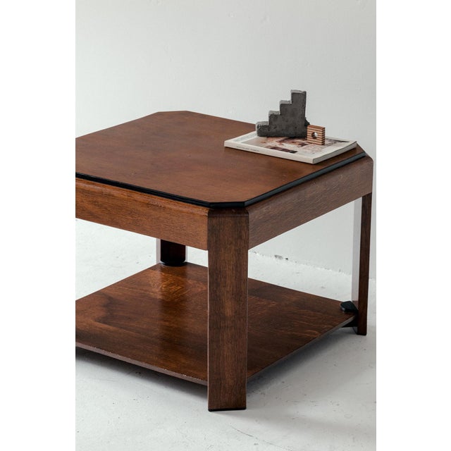 Dutch art deco coffee table produced around 1940. Square table with chamfered corners and black lacquered details. In good...