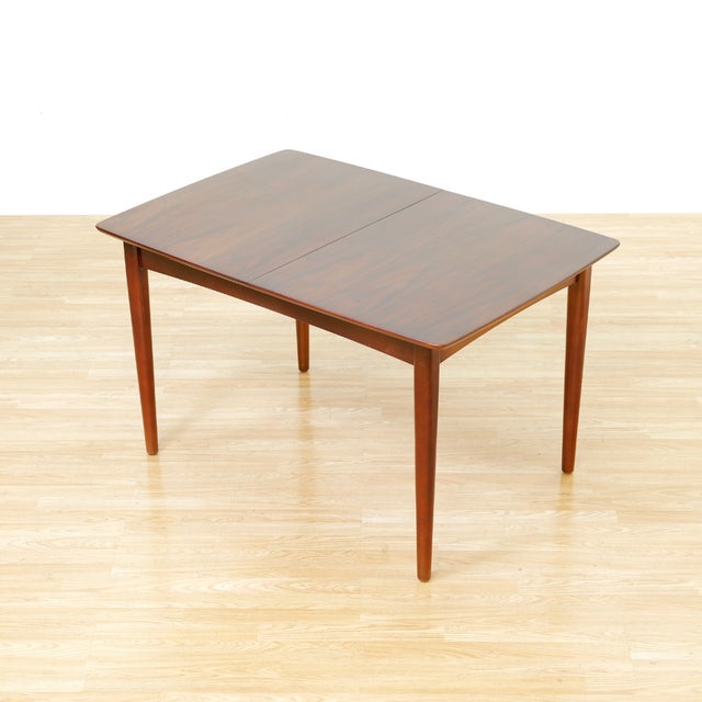 This vintage mid-century dining table was produced in England during the 1960s. Produced in walnut this extending table...