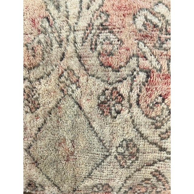 Moroccan floor pouf made from an abstract midcentury rug handwoven in shades of muted pink, gray and beige hand spun wool....